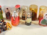 a lot of different glass vases with dolls inside of them