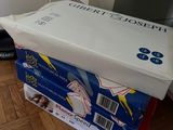 a cat sitting on top of a box on the floor