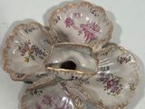 a small flower shaped dish on a white table
