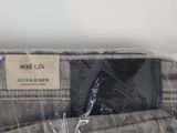 the back of a pair of gray pants wrapped in plastic