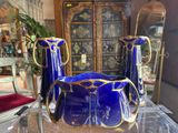 two blue vases sitting on a table in a room