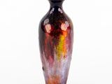 a vase that is sitting on a white surface
