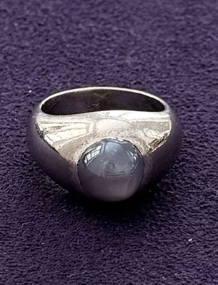 silver ring with a blue stone in the middle of it