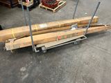 several pieces of wood are stacked on a cart in a warehouse