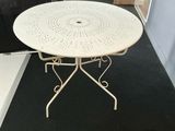 a white table that is sitting on a black carpet