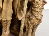 an image of a statue of a man with a dog