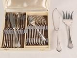 a box with silverware in it on a white surface