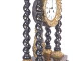 a black and gold clock sitting on top of a table