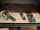 two pieces of metal sitting on top of a wooden table