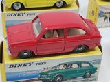 three toy cars that are sitting in boxes on a table