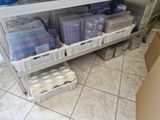 a lot of plastic containers on a shelf in a room
