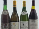 quatre bouteilles de vin sont alignées sur une table