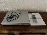 a laptop and a remote sitting on a wooden table