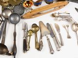 many different types of silverware on a table