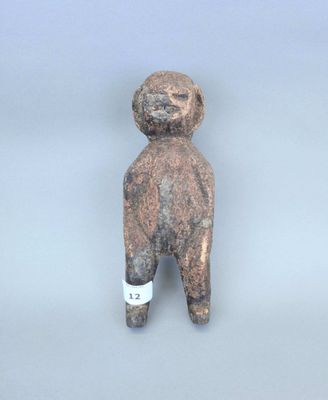 une petite figurine représentant un homme coiffé d'un chapeau