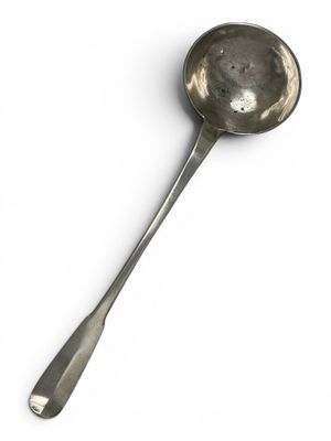 an old spoon with a spoon handle on a white surface