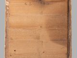 an old wooden cutting board sitting on top of a gray surface