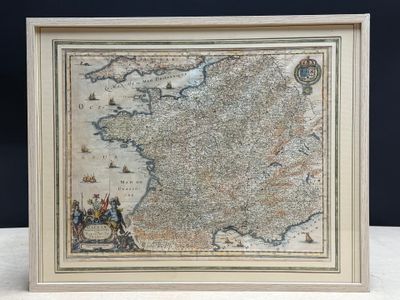 an old map of france is displayed in a frame on a table