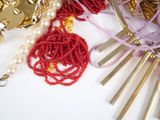 a close up of a necklace with beads and beads on it