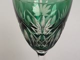 a green wine glass sitting on top of a table