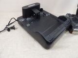 a remote control and a charger sitting on a table