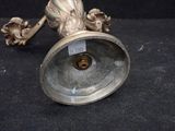 a silver candle holder on a black background