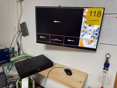 a computer monitor on a desk with a mouse and keyboard