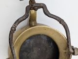 an old brass plate with a handle on a white background