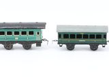 three toy trains that are sitting next to each other on a white surface