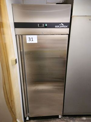 a stainless steel refrigerator in the corner of a kitchen