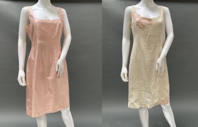 three mannequins in different colors of dresses on a mannequin