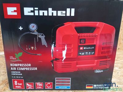 a box of a red air compressor sitting on top of a table