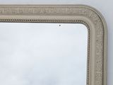 a mirror on the wall with a sky in the background
