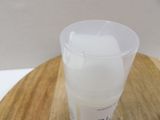 a plastic cup that is sitting on a wooden table