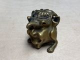 a small statue of a lion on a table