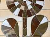 a stained glass window with a flower on it