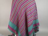 a pink and green striped shawl draped over a mannequin mannequin mannequin mannequin mannequin mannequin mannequin mann