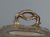 an antique silverplated casserole dish with lid and handles