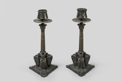 pair of bronze candlesticks with green glass tops