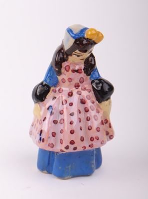 a figurine of a woman in a pink dress and hat