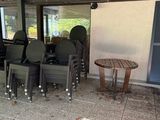 a table and chairs set up under a covered patio