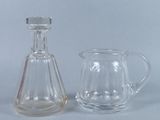 un pichet en verre et une cruche en verre posés l'un à côté de l'autre