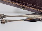 two spoons that are sitting next to a box