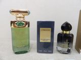 three different perfumes are sitting on a table next to each other