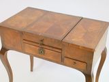 a small wooden table with two drawers on it