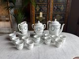 a white table with a bunch of cups and saucers on it