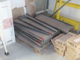 a pile of boxes and boxes on a pallet in a garage