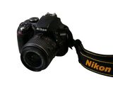 a black camera with a yellow strap attached to it