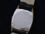 a close up of a watch on a black surface