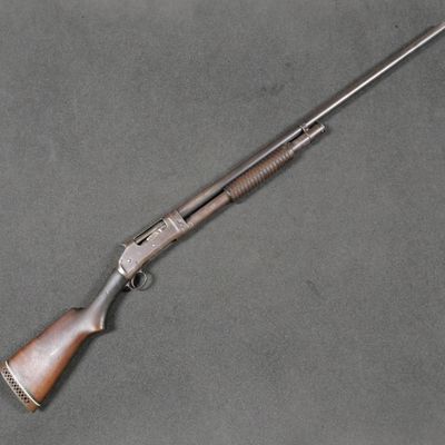 a rifle with a wooden barrel and a metal handle